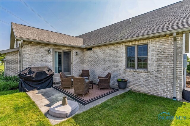 3112 Jacob Dr, Findlay, OH 45840 - back of house with roof with shingles, a lawn, a patio, and brick siding