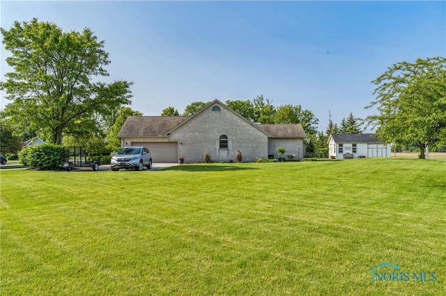 3112 Jacob Dr, Findlay, OH 45840 - view of property exterior with a yard, an attached garage, and an outbuilding
