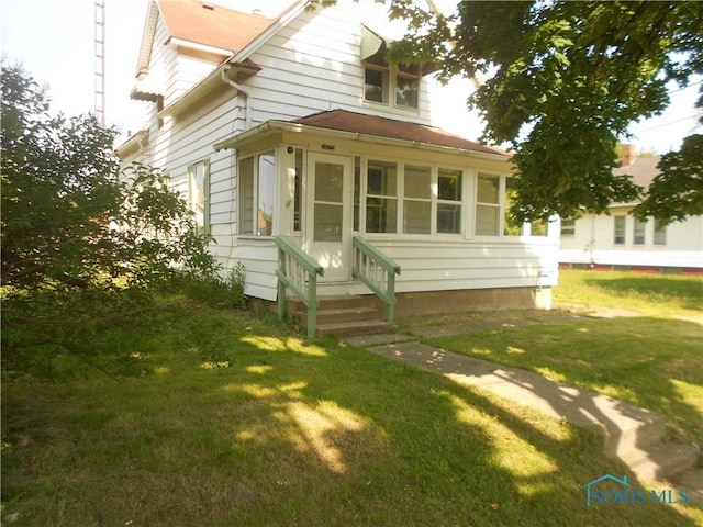 2815 Mulberry St, Toledo, OH 43608 - back of house with entry steps, a yard, and roof with shingles