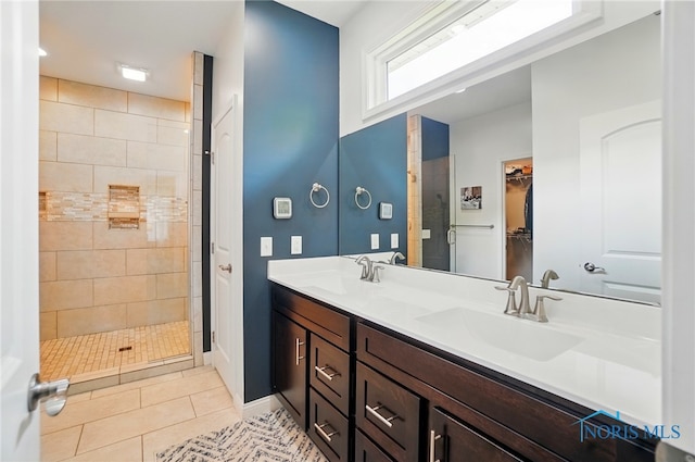 16187 Sugar Maple Ct, Findlay, OH 45840 - bathroom featuring tile patterned floors, double vanity, a shower stall, baseboards, and a walk in closet