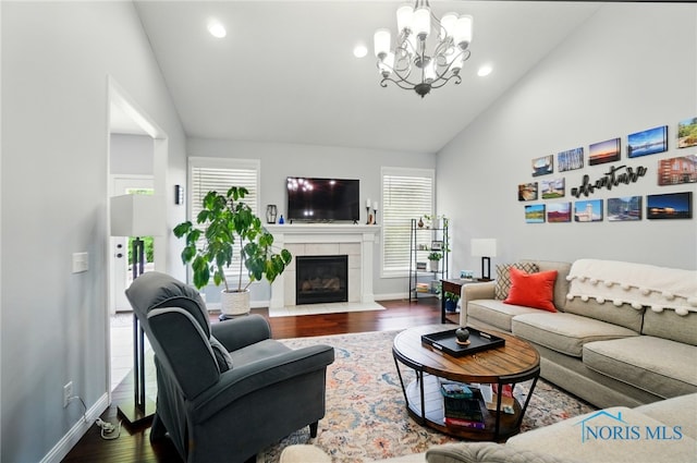 16187 Sugar Maple Ct, Findlay, OH 45840 - living area with vaulted ceiling, dark wood-type flooring, a chandelier, baseboards, and a fireplace