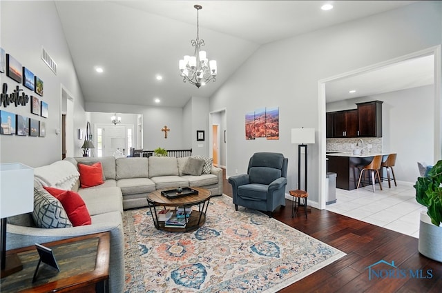 16187 Sugar Maple Ct, Findlay, OH 45840 - living room featuring a chandelier, light wood-style floors, recessed lighting, and high vaulted ceiling