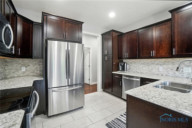 16187 Sugar Maple Ct, Findlay, OH 45840 - kitchen featuring stainless steel appliances, a sink, light tile patterned floors, and light stone counters