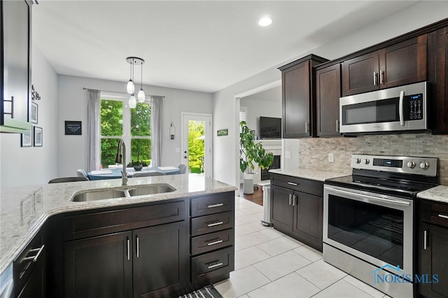 16187 Sugar Maple Ct, Findlay, OH 45840 - kitchen with stainless steel appliances, a sink, light stone countertops, and recessed lighting