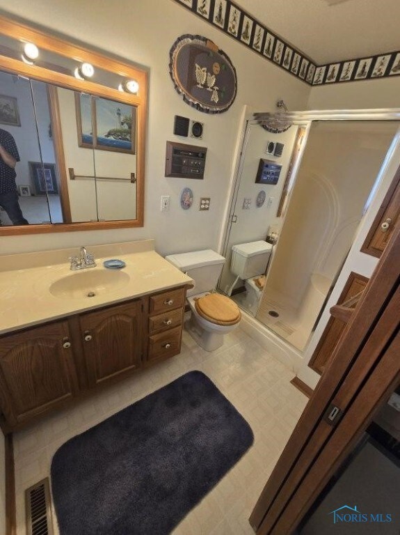 2111 Cobblestone Dr, Findlay, OH 45840 - full bath featuring toilet, a shower stall, vanity, and tile patterned floors