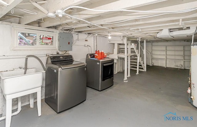 1129 Mason St, Toledo, OH 43605 - unfinished below grade area with electric panel, washing machine and dryer, and a sink