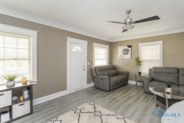 1129 Mason St, Toledo, OH 43605 - living area featuring ceiling fan, baseboards, and light wood-style flooring