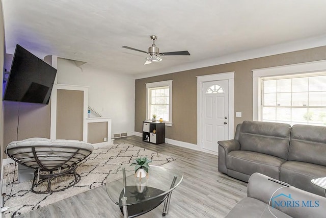 1129 Mason St, Toledo, OH 43605 - living area with a ceiling fan, wood finished floors, and baseboards