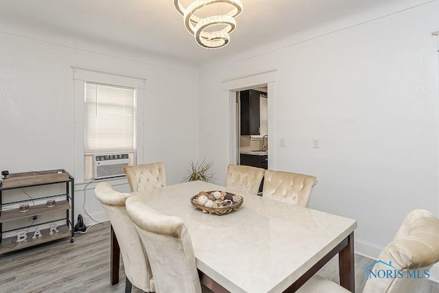 1129 Mason St, Toledo, OH 43605 - dining room featuring cooling unit, a chandelier, and light wood-style floors