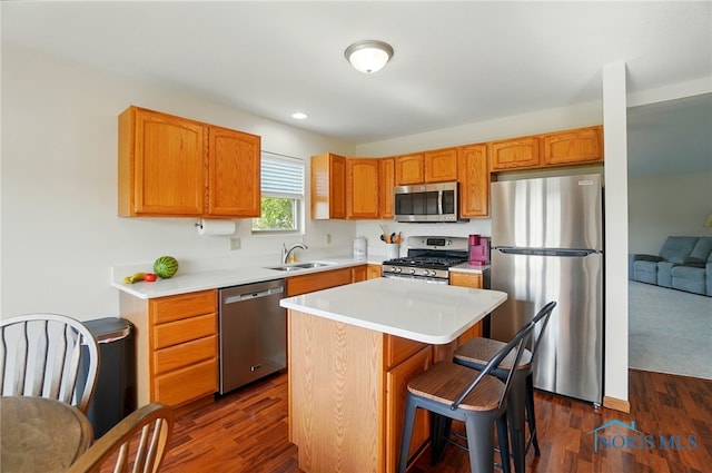 300 Winter Pine Dr Unit U300, Findlay, OH 45840 - kitchen featuring stainless steel appliances, a sink, light countertops, a kitchen island, and dark wood finished floors