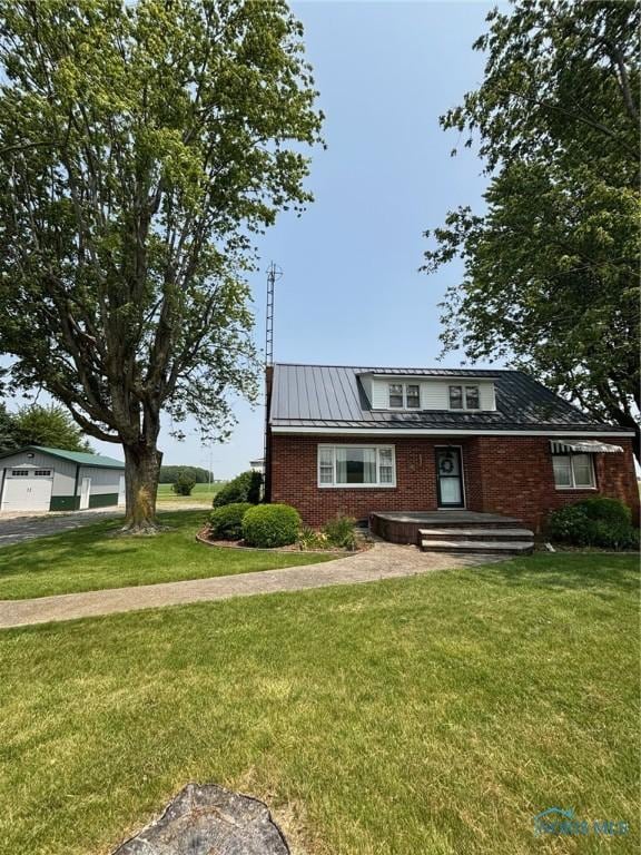 28335 Allen Rd, Defiance, OH 43512 - view of front of home with a garage, brick siding, a front lawn, and metal roof