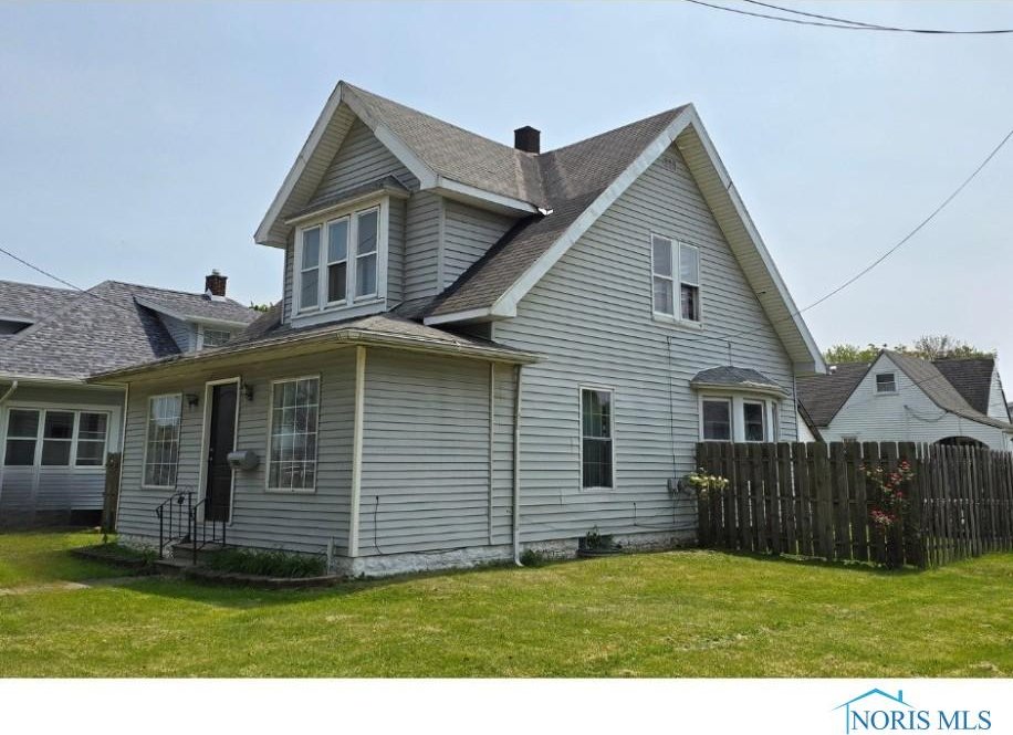 3146 131st St, Toledo, OH 43611 - view of home's exterior featuring roof with shingles and a chimney