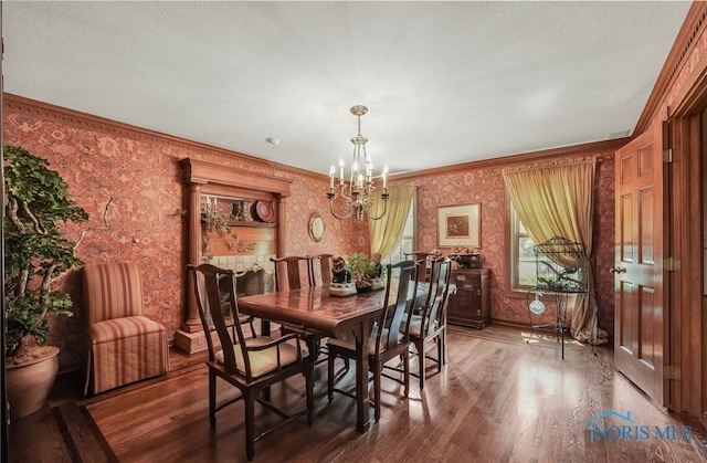 25840 W River Rd, Perrysburg, OH 43551 - dining area featuring wallpapered walls, a chandelier, wood finished floors, crown molding, and baseboards