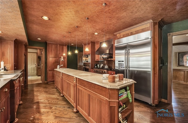 25840 W River Rd, Perrysburg, OH 43551 - kitchen featuring stainless steel built in fridge, wall chimney exhaust hood, dark wood-style flooring, a center island, and light stone countertops
