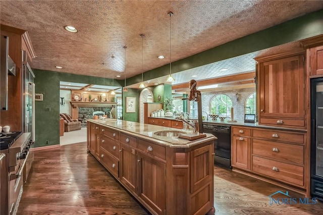 25840 W River Rd, Perrysburg, OH 43551 - kitchen featuring dishwasher, a kitchen island with sink, a sink, open floor plan, and dark wood-type flooring