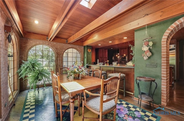 25840 W River Rd, Perrysburg, OH 43551 - dining room featuring arched walkways, brick wall, a skylight, and wood ceiling with exposed beams