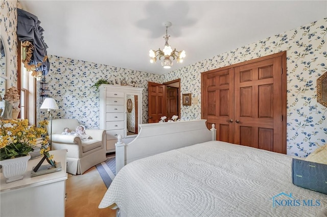 25840 W River Rd, Perrysburg, OH 43551 - carpeted bedroom featuring wallpapered walls, a chandelier, and a closet