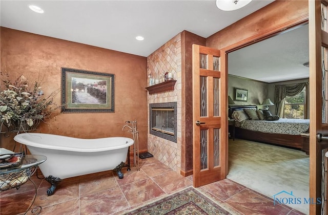 25840 W River Rd, Perrysburg, OH 43551 - bathroom featuring connected bathroom, a freestanding bath, a large fireplace, and recessed lighting