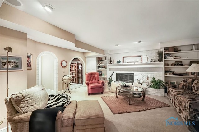 25840 W River Rd, Perrysburg, OH 43551 - living room with arched walkways, carpet, baseboards, a brick fireplace, and built in features