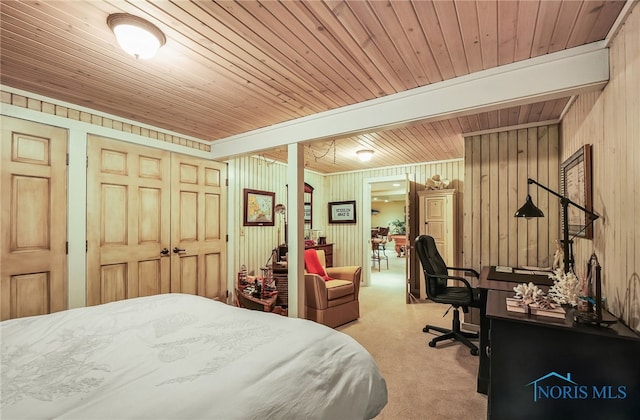 25840 W River Rd, Perrysburg, OH 43551 - bedroom featuring carpet floors, wood ceiling, wooden walls, an office area, and a closet
