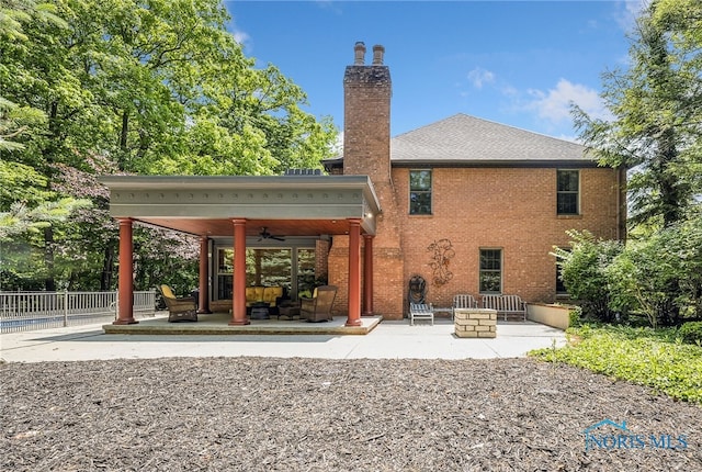 25840 W River Rd, Perrysburg, OH 43551 - rear view of property with ceiling fan, a patio area, a chimney, and brick siding