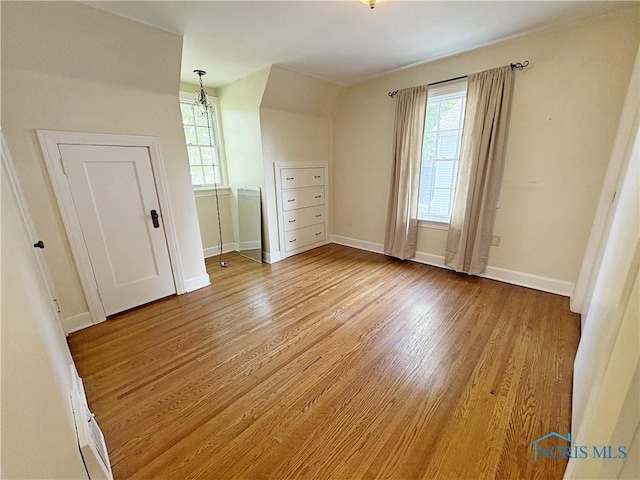 932 N Grove St, Bowling Green, OH 43402 - unfurnished bedroom featuring wood finished floors, multiple windows, and baseboards