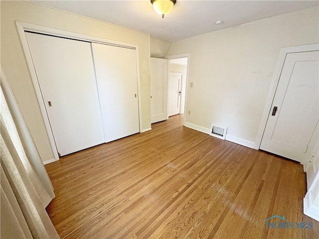 932 N Grove St, Bowling Green, OH 43402 - unfurnished bedroom with light wood-type flooring, a closet, and baseboards