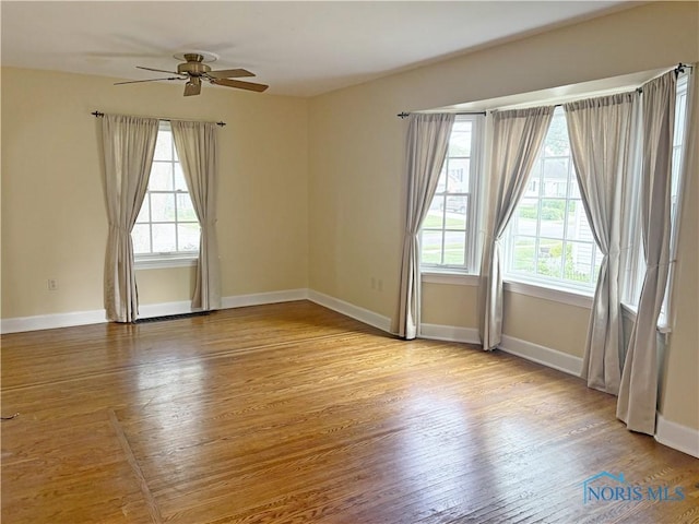 932 N Grove St, Bowling Green, OH 43402 - empty room with plenty of natural light, wood finished floors, a ceiling fan, and baseboards