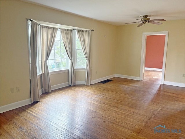 932 N Grove St, Bowling Green, OH 43402 - unfurnished room with wood finished floors, baseboards, and a ceiling fan