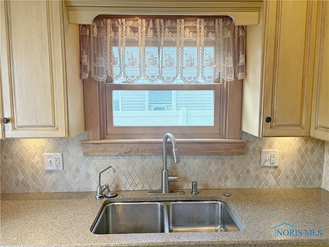 932 N Grove St, Bowling Green, OH 43402 - kitchen featuring a sink, decorative backsplash, and light stone countertops