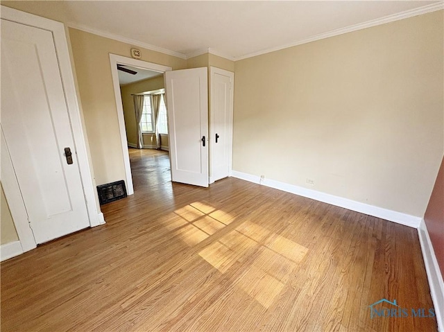 932 N Grove St, Bowling Green, OH 43402 - unfurnished room featuring light wood-type flooring, baseboards, and ornamental molding
