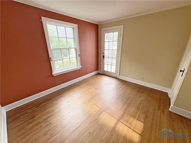 932 N Grove St, Bowling Green, OH 43402 - empty room featuring ornamental molding, wood finished floors, and baseboards