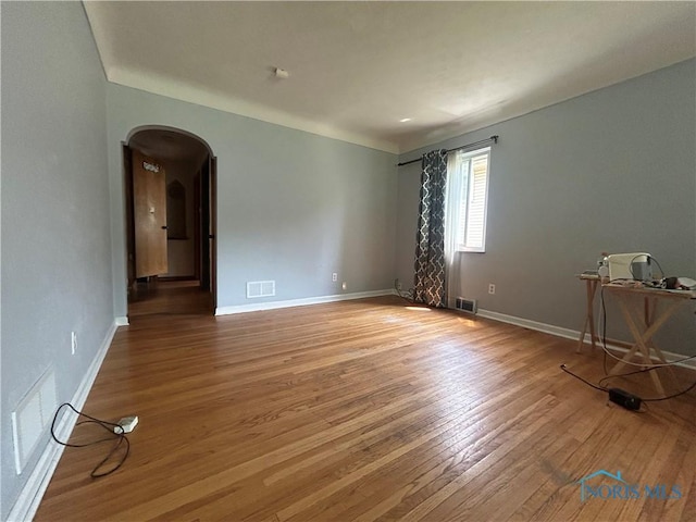 3030 Colby Dr, Toledo, OH 43614 - unfurnished room with arched walkways, wood finished floors, and baseboards