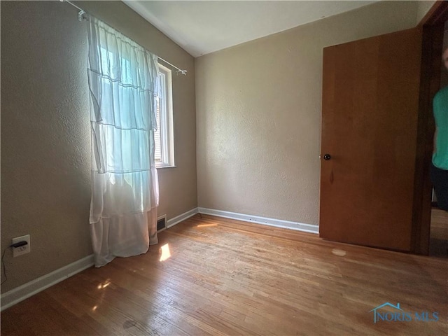 3030 Colby Dr, Toledo, OH 43614 - unfurnished room with wood finished floors, a textured wall, and baseboards