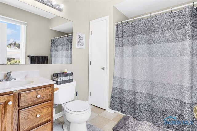 224 Elm St, Rossford, OH 43460 - bathroom with vanity, toilet, tile patterned floors, and a shower with shower curtain