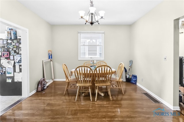 224 Elm St, Rossford, OH 43460 - dining area featuring a chandelier, wood finished floors, and baseboards