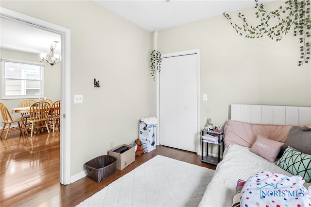 224 Elm St, Rossford, OH 43460 - bedroom with a chandelier, wood finished floors, and a closet