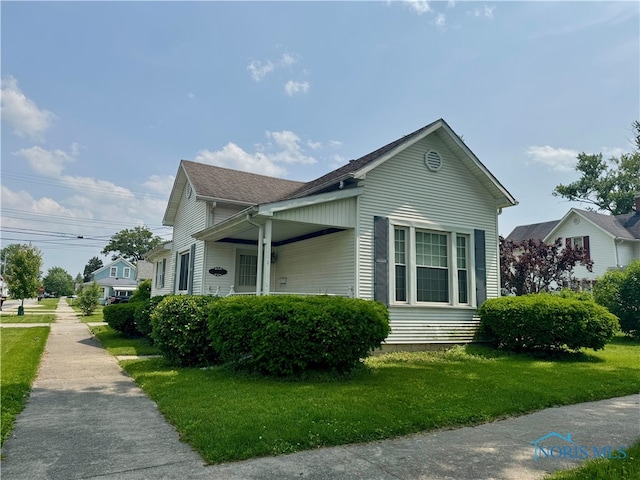 1001 Wilhelm St, Defiance, OH 43512 - view of home's exterior with a yard and roof with shingles