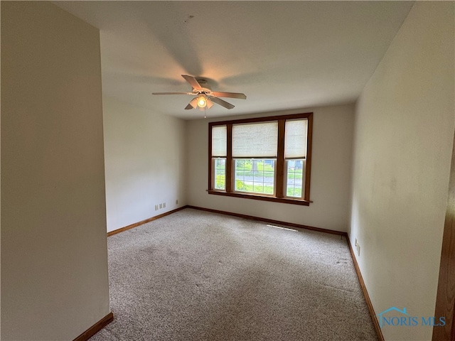 1001 Wilhelm St, Defiance, OH 43512 - spare room with baseboards, carpet floors, and a ceiling fan