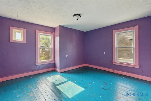 715 Nicholas St, Toledo, OH 43609 - empty room featuring hardwood / wood-style flooring, baseboards, and a textured ceiling