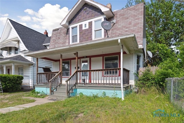 715 Nicholas St, Toledo, OH 43609 - view of front facade featuring covered porch, a shingled roof, and a chimney