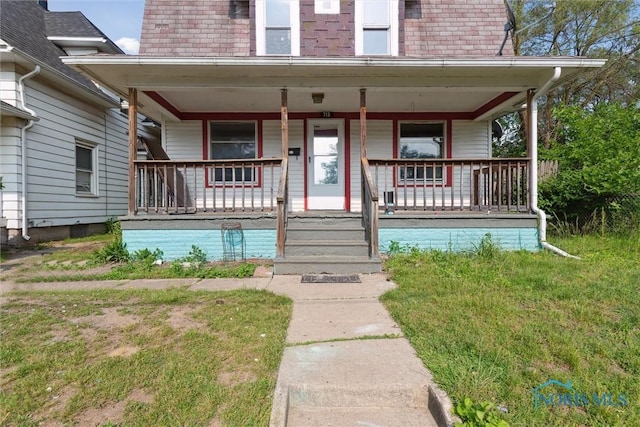715 Nicholas St, Toledo, OH 43609 - view of front facade featuring covered porch and mansard roof