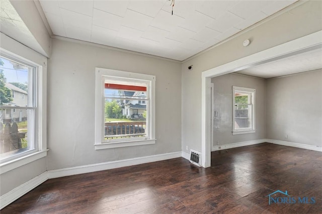 715 Nicholas St, Toledo, OH 43609 - unfurnished room featuring healthy amount of natural light, wood-type flooring, and baseboards