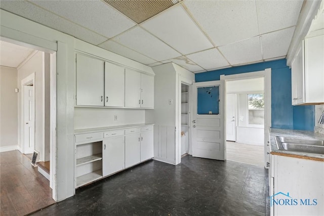 715 Nicholas St, Toledo, OH 43609 - kitchen with a sink, white cabinetry, a paneled ceiling, and light countertops