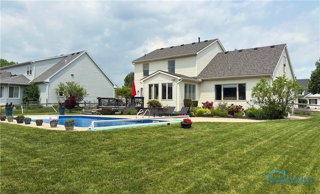 7663 Cortland Ct, Holland, OH 43528 - rear view of house featuring a wooden deck, an outdoor pool, and a shingled roof
