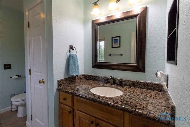 7663 Cortland Ct, Holland, OH 43528 - bathroom featuring vanity, toilet, tile patterned floors, and a textured wall