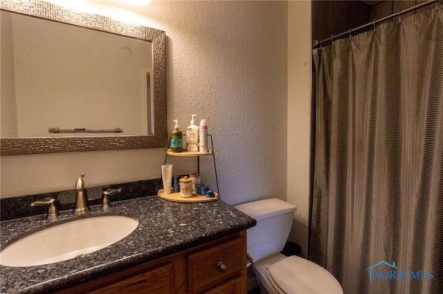 7663 Cortland Ct, Holland, OH 43528 - full bathroom with a textured wall, vanity, toilet, and curtained shower
