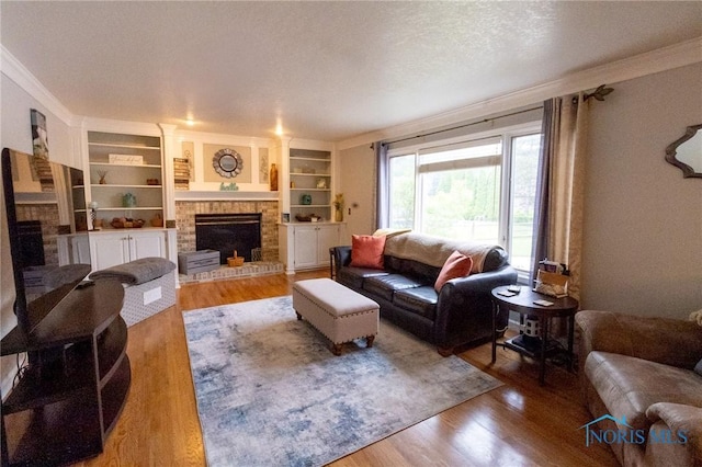 7663 Cortland Ct, Holland, OH 43528 - living area featuring a fireplace, crown molding, wood finished floors, built in shelves, and a textured ceiling
