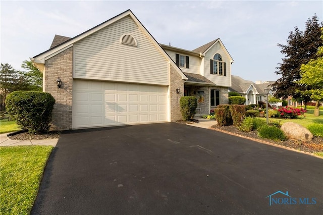 7663 Cortland Ct, Holland, OH 43528 - traditional-style home featuring asphalt driveway and brick siding
