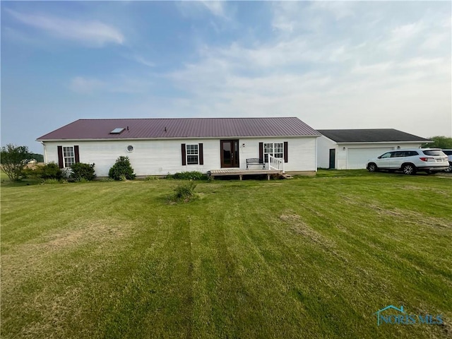 7774 Scott Rd, Edgerton, OH 43517 - single story home featuring a front lawn, a wooden deck, and metal roof